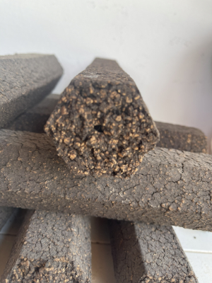 Close-up of hexagonal OliveHeat briquettes showing quality and structure