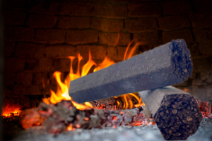 OliveHeat briquettes burning in cozy Cyprus fireplace